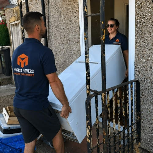 Morris Movers team carrying a large household appliance from a property during a flexible moving and transport service in Thanet.