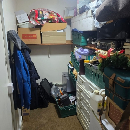 Small storage room filled with boxes, clothing, tools and household belongings before a decluttering and clearance service in Thanet.