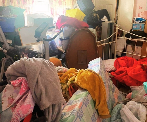 Bedroom filled with furniture, bedding and household belongings before a Morris Movers house clearance in Thanet.