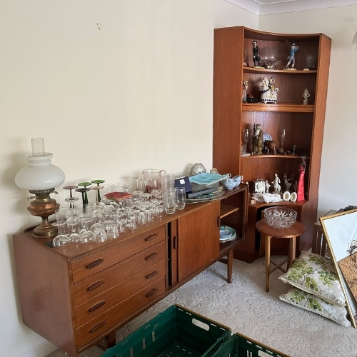 Wooden cabinets, glassware and decorative household items identified for reuse or resale during a Morris Movers house clearance in Thanet.